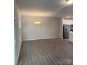 Bright living room and kitchen combo with modern flooring and fixtures at 7 Scott Sw St, Concord, NC 28025