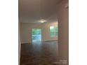 Spacious living room with sliding glass door and ample natural light at 7 Scott Sw St, Concord, NC 28025