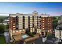 Multi-story building with brick and stucco accents featuring balconies and a pool at 715 N Church St # 613, Charlotte, NC 28202