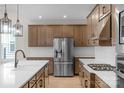 Spacious kitchen with stainless steel refrigerator, white subway tile backsplash, and ample counter space at 7332 Jolly Brook Dr, Charlotte, NC 28215