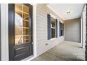 Inviting covered front porch showcasing stylish windows, classic shutters, and an elegant front door at 7517 Lancaster Hwy # 5, Waxhaw, NC 28173