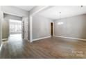 Bright living room featuring light hardwood floors, neutral walls, and modern light fixtures at 7517 Lancaster Hwy # 5, Waxhaw, NC 28173