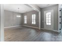 Spacious living room with light wood flooring, abundant natural light, and a classic chandelier at 7517 Lancaster Hwy # 5, Waxhaw, NC 28173
