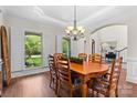 Dining room featuring wood table, large window with shutters, and hardwood floors at 9918 Windrow Dr, Indian Trail, NC 28079