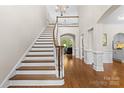 Elegant foyer with hardwood floors, staircase, chandelier, and views into other rooms at 9918 Windrow Dr, Indian Trail, NC 28079