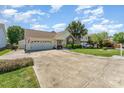 Inviting home exterior showcasing well-kept lawn, long driveway, and attached two-car garage at 1076 Braxton Dr, Concord, NC 28025