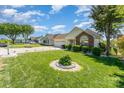Attractive home featuring lush front lawn with garden features, a long driveway, and an attached garage at 1076 Braxton Dr, Concord, NC 28025