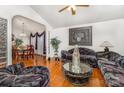 Spacious living room with hardwood floors that flows into the adjacent dining area for entertaining at 1076 Braxton Dr, Concord, NC 28025