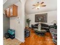 Cozy living room features hardwood floors, a ceiling fan, and traditional decor at 1076 Braxton Dr, Concord, NC 28025