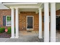 Inviting entrance with stately columns and a stylish black door at 11209 Lazio Ln # 1, Charlotte, NC 28277