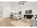 Open-concept living space with modern furnishings and views of the kitchen at 1129 Thayer Glen Ct, Charlotte, NC 28213