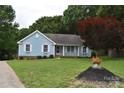 Charming blue home with a well-maintained lawn and a vibrant red maple tree adding a pop of color at 117 Blackberry Ln # 66, Mooresville, NC 28117