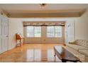 Sun-drenched living room boasts hardwood floors, a chandelier, and comfortable seating at 1184 Cambridge Dr, Shelby, NC 28152