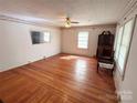 Bright and spacious living room with beautiful hardwood floors, ceiling fan, and plenty of natural light at 125 Hunter St, Salisbury, NC 28144