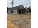 An unfinished home shows exterior with covered porch and newly installed roof at 128 Loblolly Dr, Mount Gilead, NC 27306