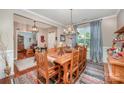 Dining room featuring wood table, chandelier and beautiful curtains at 12832 Heath Grove Dr, Huntersville, NC 28078