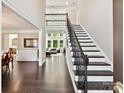 Elegant foyer with a staircase, hardwood floors, and abundant natural light at 129 Overlook Ridge Ln, Davidson, NC 28036