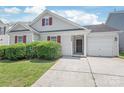 Inviting single-story home with an attached garage and neat front yard at 13408 Golden Apple Ct, Charlotte, NC 28215