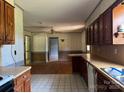 Cozy eat-in kitchen with wooden cabinets, neutral countertops and tile flooring at 140 Porter Rd, Statesville, NC 28625