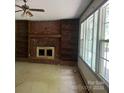 Living room featuring a brick fireplace, built-in shelves and lots of natural light at 140 Porter Rd, Statesville, NC 28625