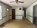 Open living room with neutral walls, painted trim and an adjacent hallway at 140 Porter Rd, Statesville, NC 28625