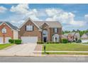 Traditional brick home featuring a well-kept lawn, two car garage, and neighborhood setting at 14104 Kendrick Cross Rd, Charlotte, NC 28273