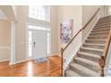 Bright foyer with hardwood floors, staircase, and elegant decor at 14104 Kendrick Cross Rd, Charlotte, NC 28273