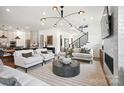 Bright living room with fireplace, modern staircase, and open layout at 14210 Kershaw Cir # 20, Huntersville, NC 28078