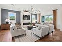 Inviting living room with modern lighting, fireplace, and plenty of natural light at 14210 Kershaw Cir # 20, Huntersville, NC 28078