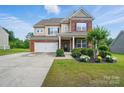 Charming two-story home with brick and beige siding, a manicured lawn, and inviting curb appeal at 14316 Baytown Ct, Charlotte, NC 28078