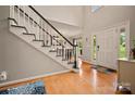 Grand foyer features hardwood floors, a staircase with black and white risers, and a welcoming entrance at 144 Chickasaw Dr, Shelby, NC 28152