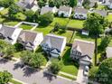 An aerial view shows the neighborhood with well-maintained homes, lush greenery, and serene atmosphere at 14501 Asheton Creek Dr, Charlotte, NC 28273