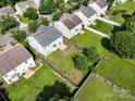 Aerial view showcases a spacious backyard with lush green grass, surrounded by a wooden fence, offering privacy at 14501 Asheton Creek Dr, Charlotte, NC 28273
