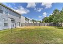 Large backyard with a well-maintained fence and a small patio area, perfect for outdoor activities at 14501 Asheton Creek Dr, Charlotte, NC 28273