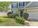Close up of a charming home featuring blue siding and meticulously maintained landscaping at 14501 Asheton Creek Dr, Charlotte, NC 28273