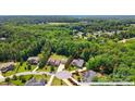 Aerial view of a home with a large, wooded lot, nestled in a lush green neighborhood at 161 Leaning Tower Dr, Mooresville, NC 28117