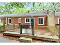 Exterior showcasing a wooden deck with horizontal railing and access to the backyard at 1809 Jameston Dr, Charlotte, NC 28209