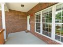 Covered front porch featuring brick facade, large windows, and a welcoming front door, perfect for relaxing at 2016 Townview Dr, Kannapolis, NC 28081