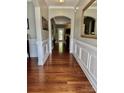 Entryway with hardwood floors, wainscoting, arched doorway, and decorative mirror at 3678 Privette Rd # 349, Matthews, NC 28104