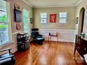 Bright living room with hardwood floors, wainscoting, and large windows at 3678 Privette Rd # 349, Matthews, NC 28104