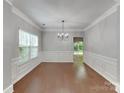 Formal dining room featuring wainscoting, hardwood floors, and an elegant chandelier at 3711 Green Pasture Rd, Charlotte, NC 28269