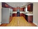 Kitchen featuring stainless steel appliances, dark cabinets, and tile backsplash at 3711 Green Pasture Rd, Charlotte, NC 28269