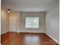 A view of a living room with hardwood floors and a large window providing natural light at 3711 Green Pasture Rd, Charlotte, NC 28269
