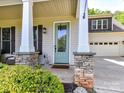 Charming front entrance with a decorative glass door and stone-accented columns at 3801 Creek Ridge Dr, Denver, NC 28037