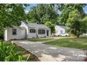 Charming home with a well-maintained lawn, complemented by a classic driveway and mature trees at 3920 Admiral Ave, Charlotte, NC 28205