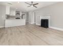 Open-concept living room boasts a decorative fireplace and modern flooring adjacent to the eat-in kitchen at 3920 Admiral Ave, Charlotte, NC 28205