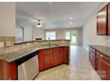 Open kitchen with stainless appliances, tiled floors, and seamless access to living area at 4006 Lawrence Daniel Dr, Matthews, NC 28104