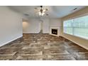 Bright living room with wood-look floors, fireplace, and ample natural light at 4006 Lawrence Daniel Dr, Matthews, NC 28104