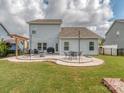 Spacious backyard with a stone patio, outdoor seating, and a well-maintained lawn at 4205 Bent Green Ln, Monroe, NC 28112
