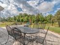 Backyard patio with outdoor seating and a view of the landscaped yard with playground at 4205 Bent Green Ln, Monroe, NC 28112